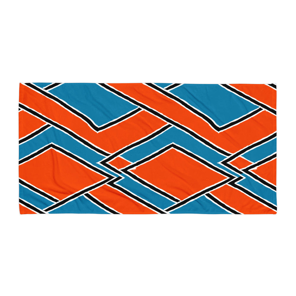 Vivid red Nana beach towel from Tintin Studios laid out flat on a white background, highlighting its bold patterns and energetic colour.