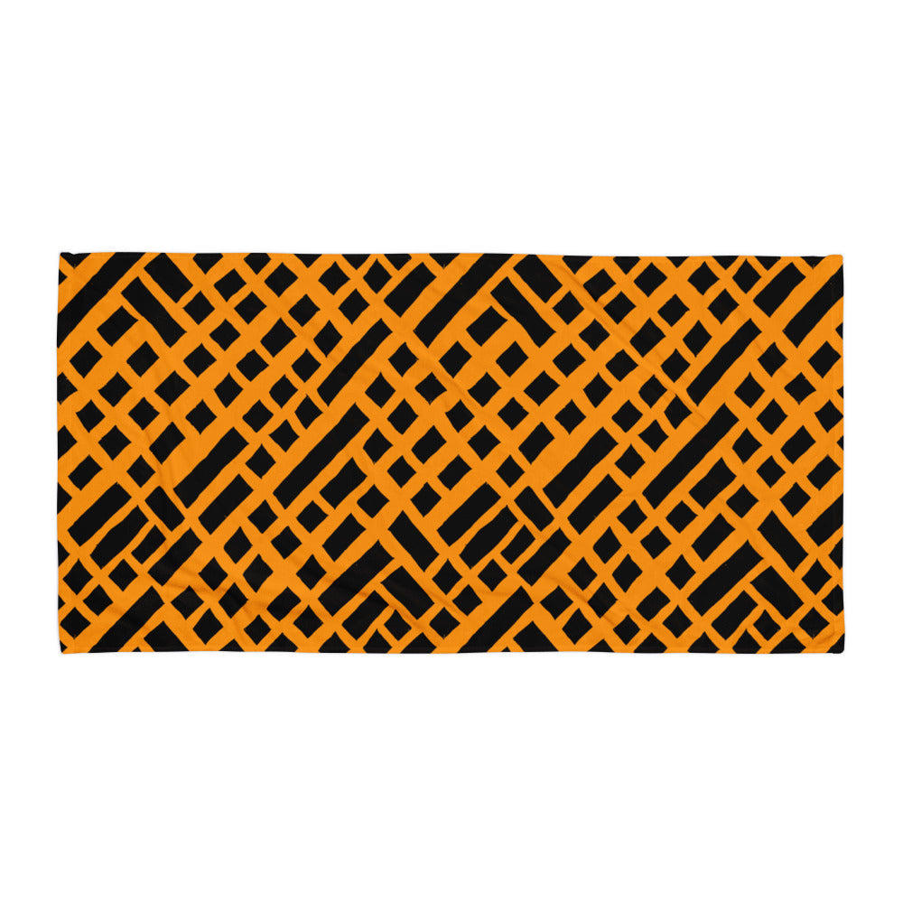 Vibrant orange Felele beach towel from Tintin Studios displayed flat on a white background, featuring its cultural patterns.