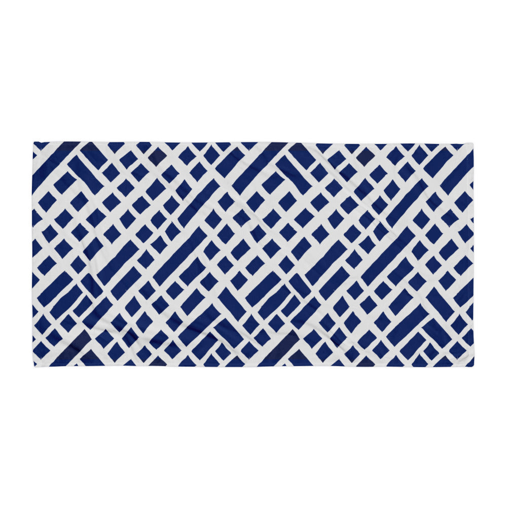 Blue Felele beach towel from Tintin Studios spread flat on a white surface, showing its distinct vibrant cultural designs.
