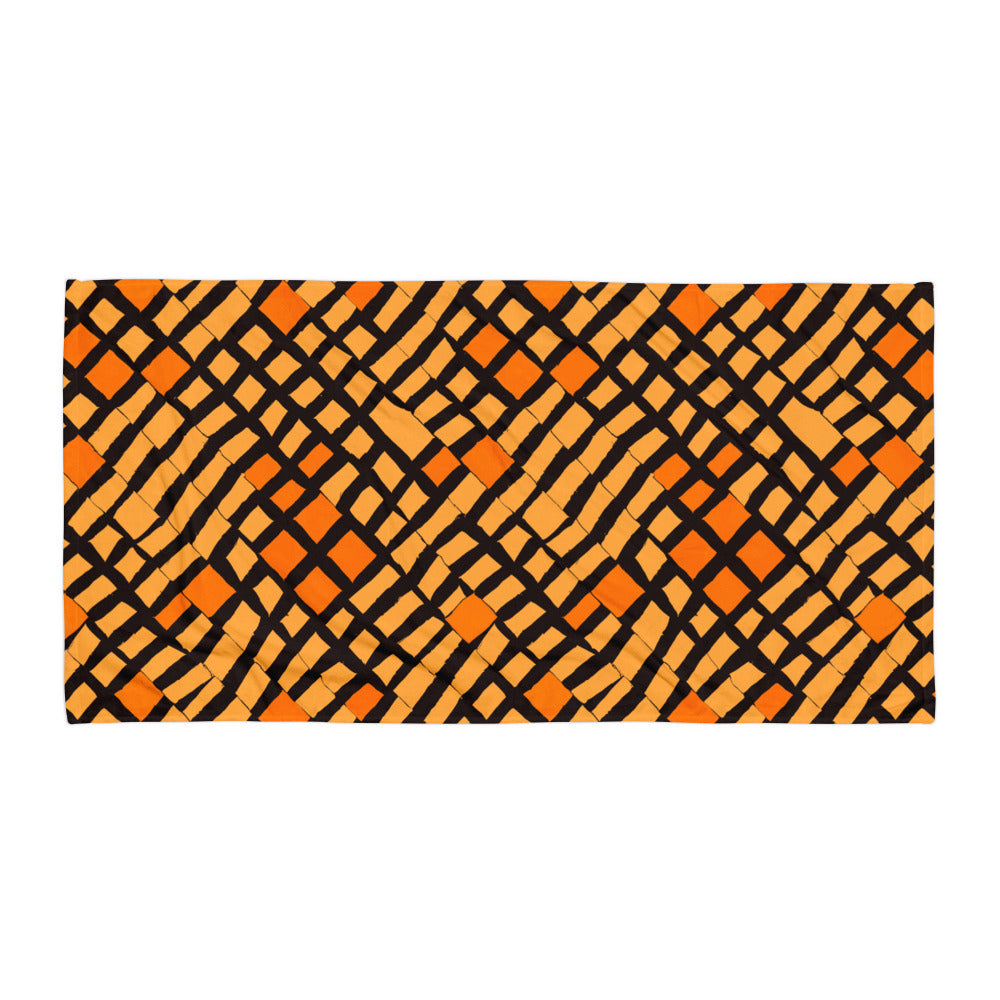 Sleek orange Lagos beach towel from Tintin Studios displayed flat on a white background, showcasing its modern and sophisticated design.