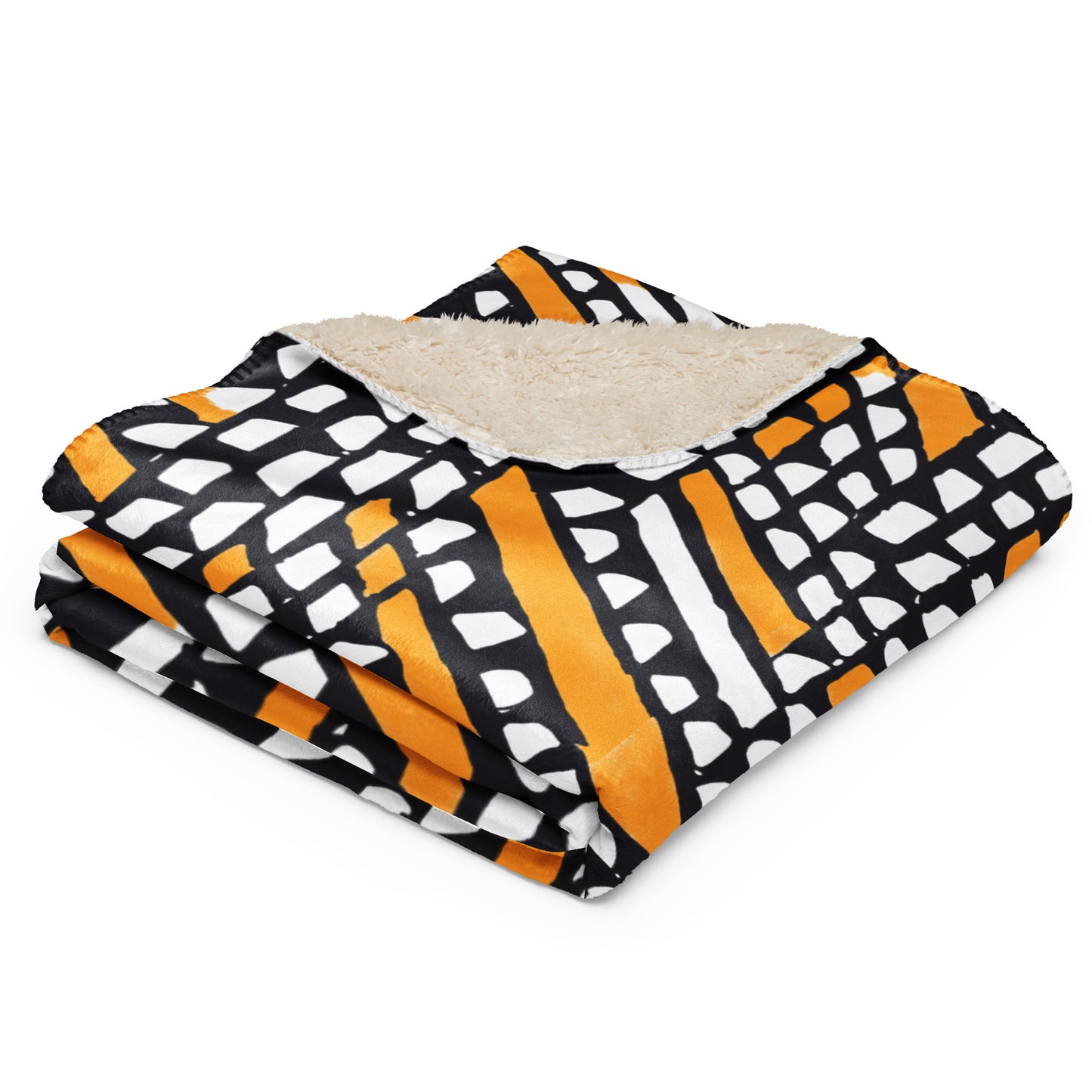 Tintin Studios' Ilorin Sherpa blanket in orange, folded to highlight the tan sherpa backing, combining rustic charm with luxurious warmth.
