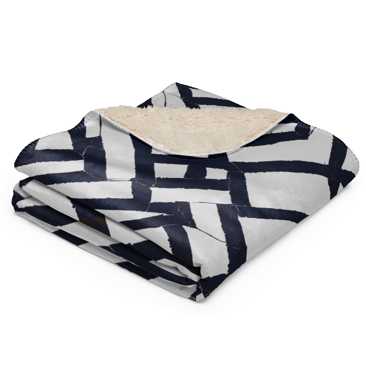 Tintin Studios' blue folded Lokoja Sherpa blanket showcasing sharp geometric patterns against its soft sherpa texture, reflecting a perfect blend of modern design and cozy warmth.