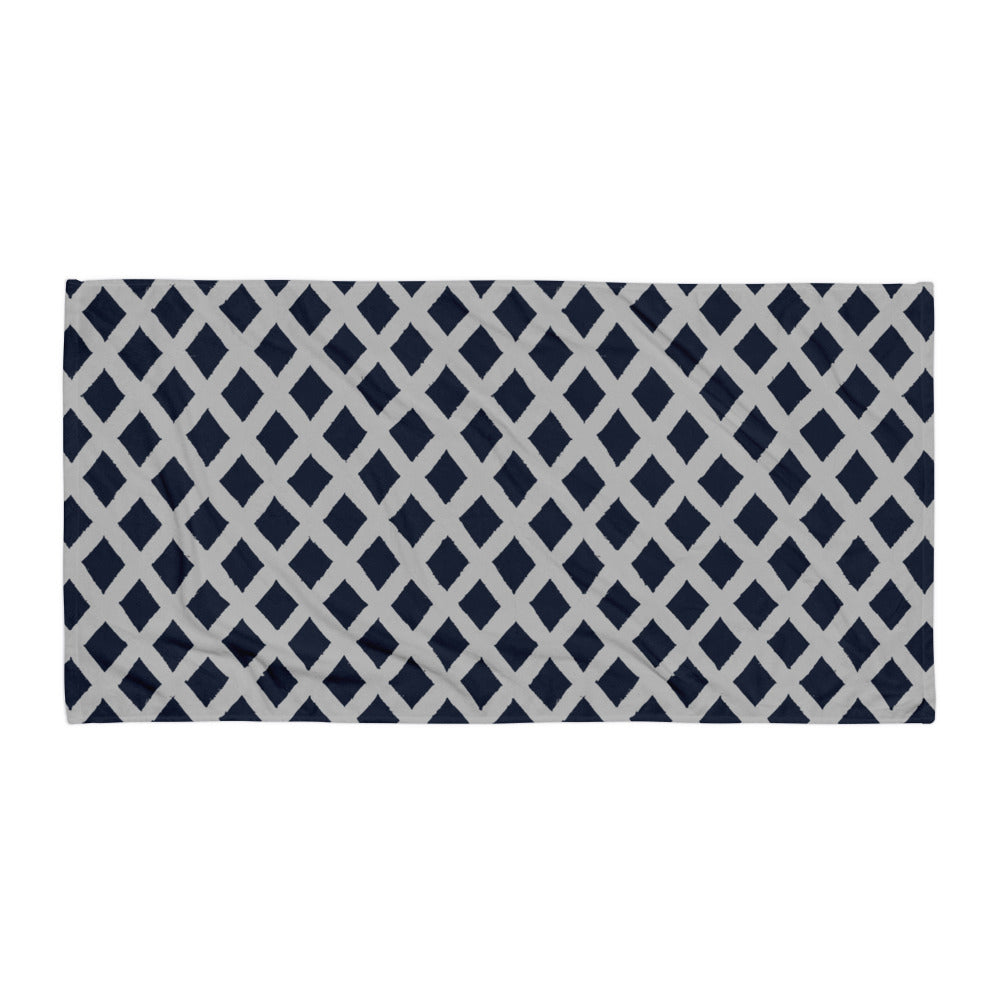 Calm blue Zaria towel from Tintin Studios laid out flat on a white background, accentuating its cool blue color and minimalistic patterns.