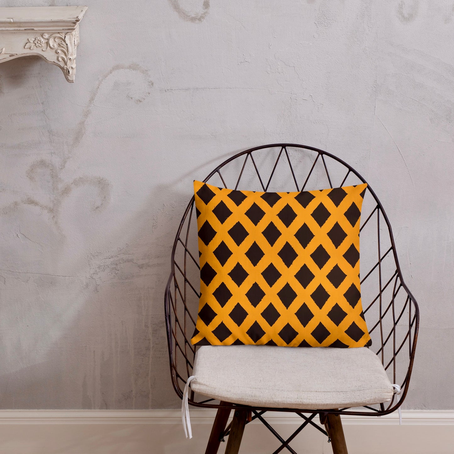 18x18 Zaria orange throw pillow from Tintin Studios, subtle and elegant on a black iron chair.