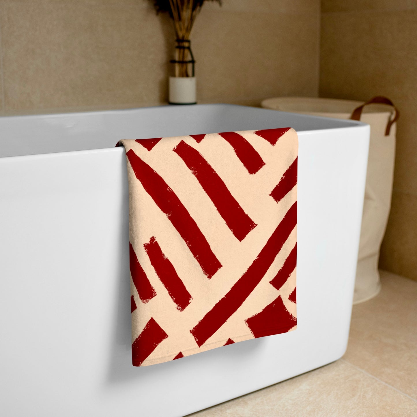 Richly colored red Tutu towel from Tintin Studios gracefully placed over a white bathtub, offering a stylish and functional addition to any bath or beach day.