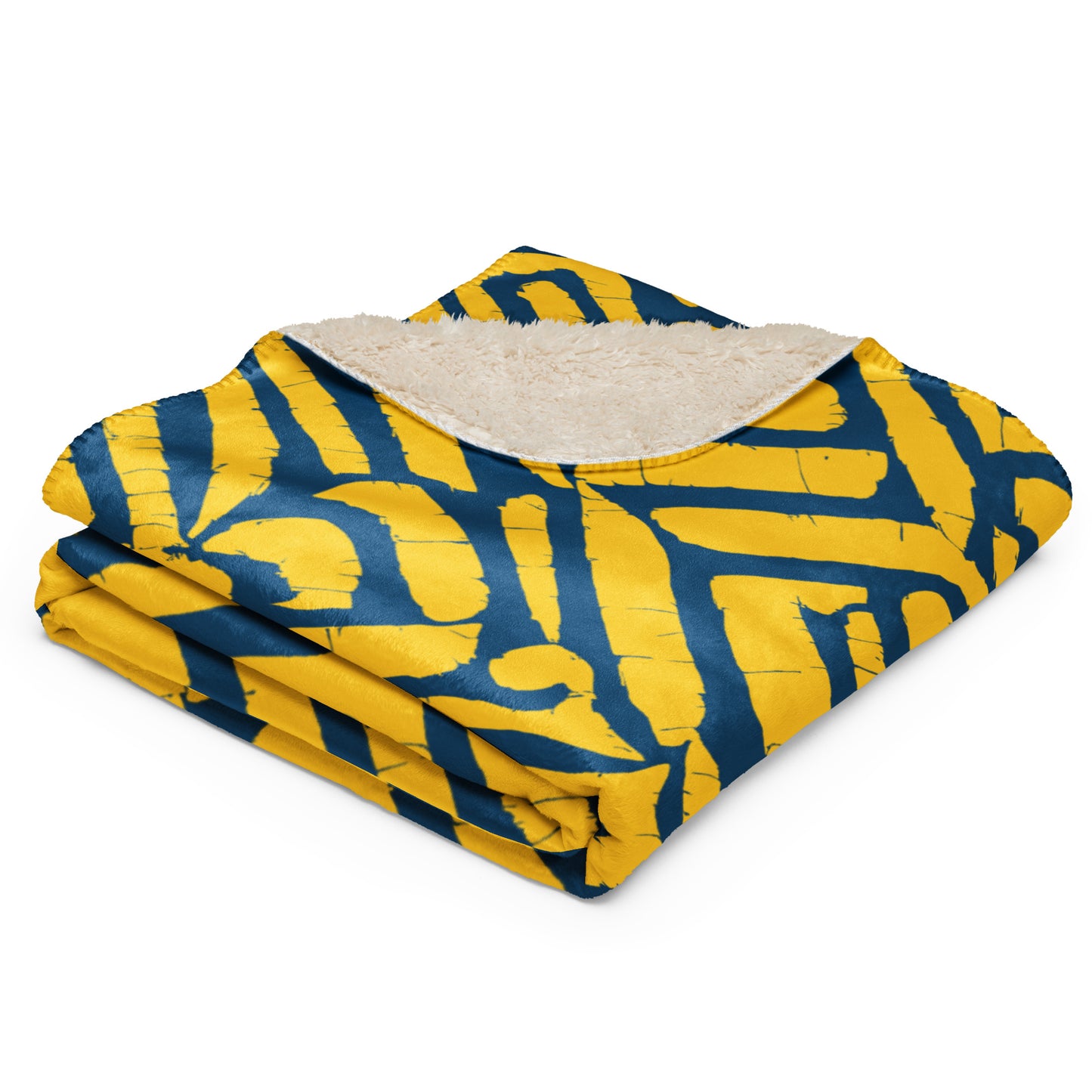 Close-up of the folded ChiChi Sherpa blanket from Tintin Studios showcasing the bold yellow and blue print with a plush sherpa underside, highlighting the exquisite craftsmanship and inviting texture, ideal for enhancing home comfort.