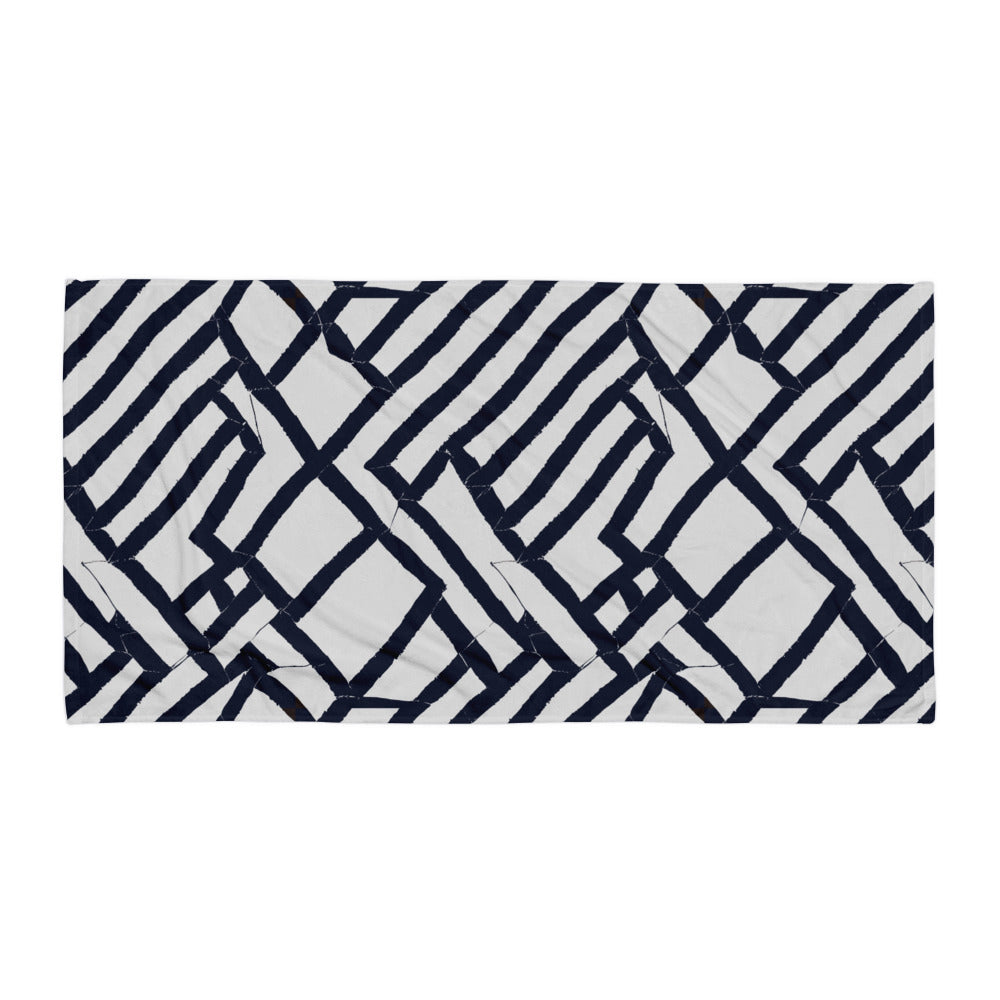 Deep blue Lokoja beach towel from Tintin Studios displayed flat on a pristine white background, showcasing its sophisticated geometric patterns and striking colour.