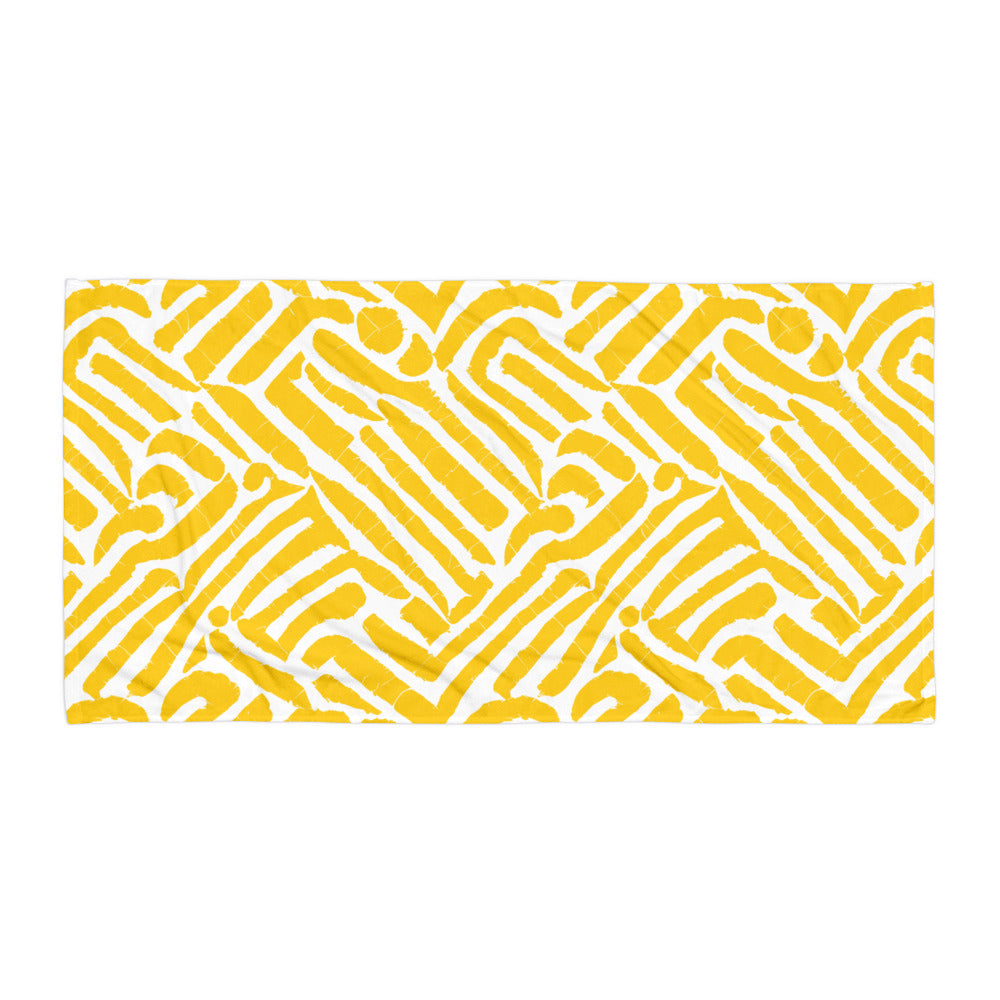 Vibrant yellow ChiChi beach towel from Tintin Studios laid out flat on a white background, displaying its playful and artistic patterns.