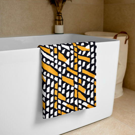 Orange Ilorin beach towel from Tintin Studios, draped over a white bathtub, ideal for a sophisticated and natural aesthetic.