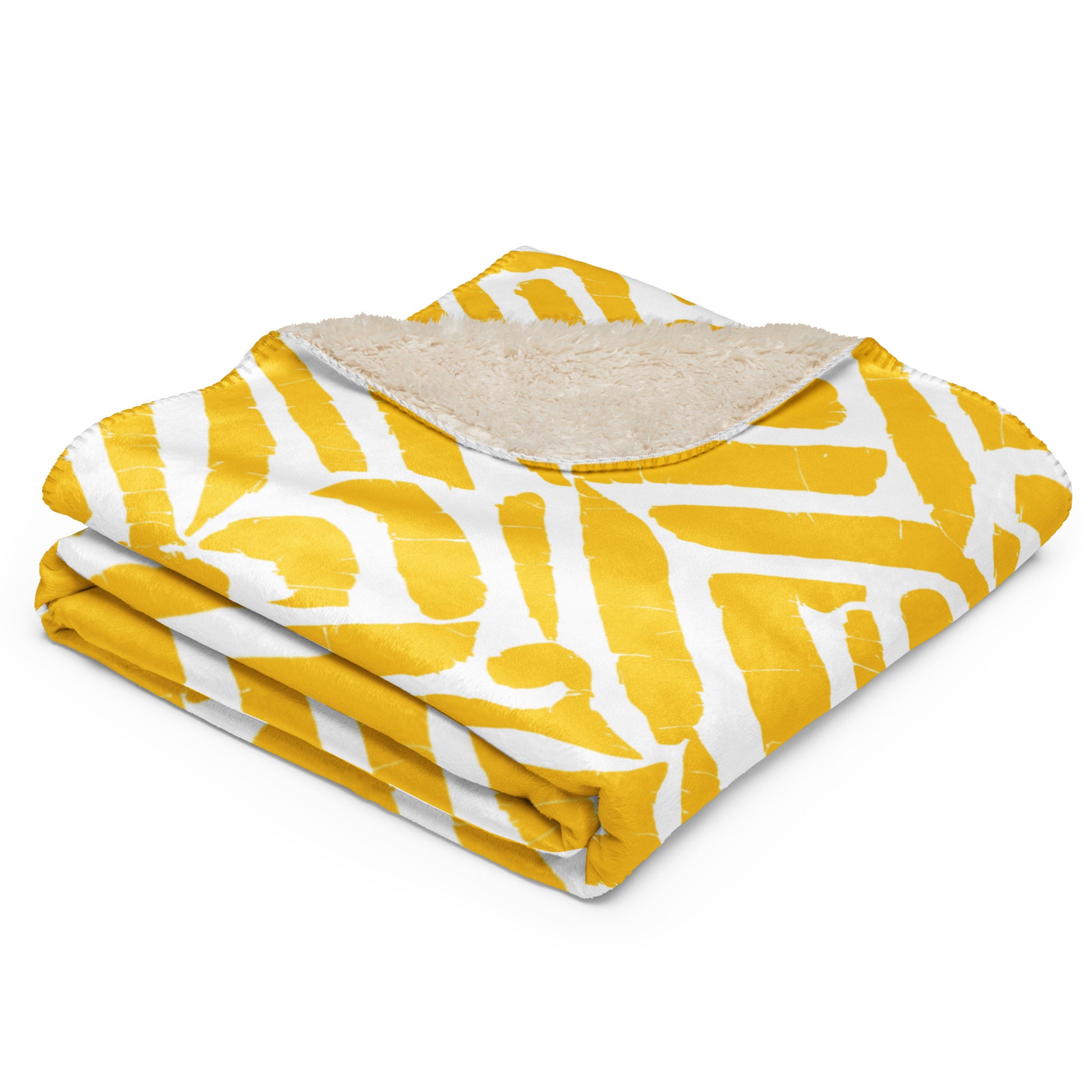 Close-up of the folded ChiChi Sherpa blanket from Tintin Studios showcasing the bold yellow and white print with a plush sherpa underside, highlighting the exquisite craftsmanship and inviting texture, ideal for enhancing home comfort.